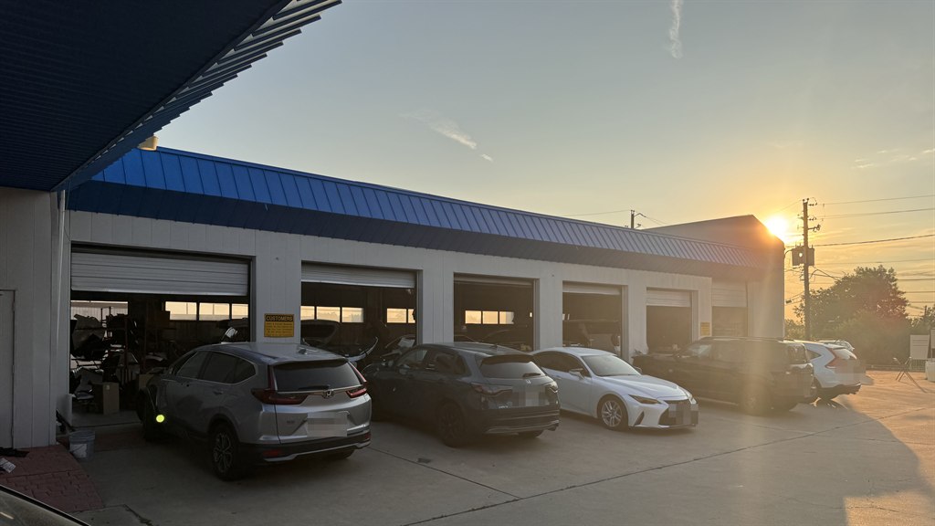The Nova Body Shop service bays on North Lamar at sunset