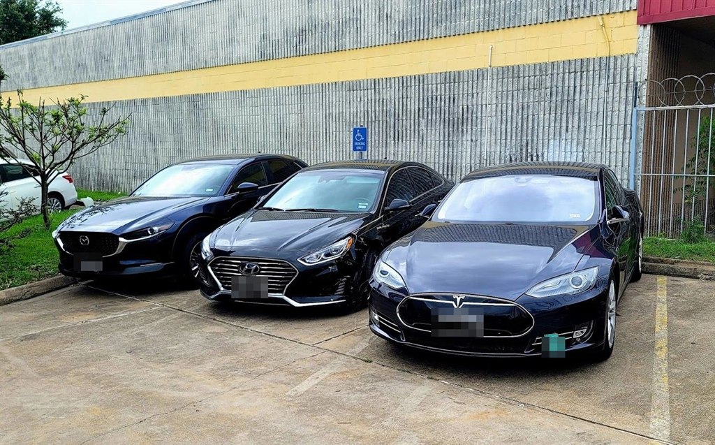 Three repaired cars parked outside Nova Body Shop, ready for pickup